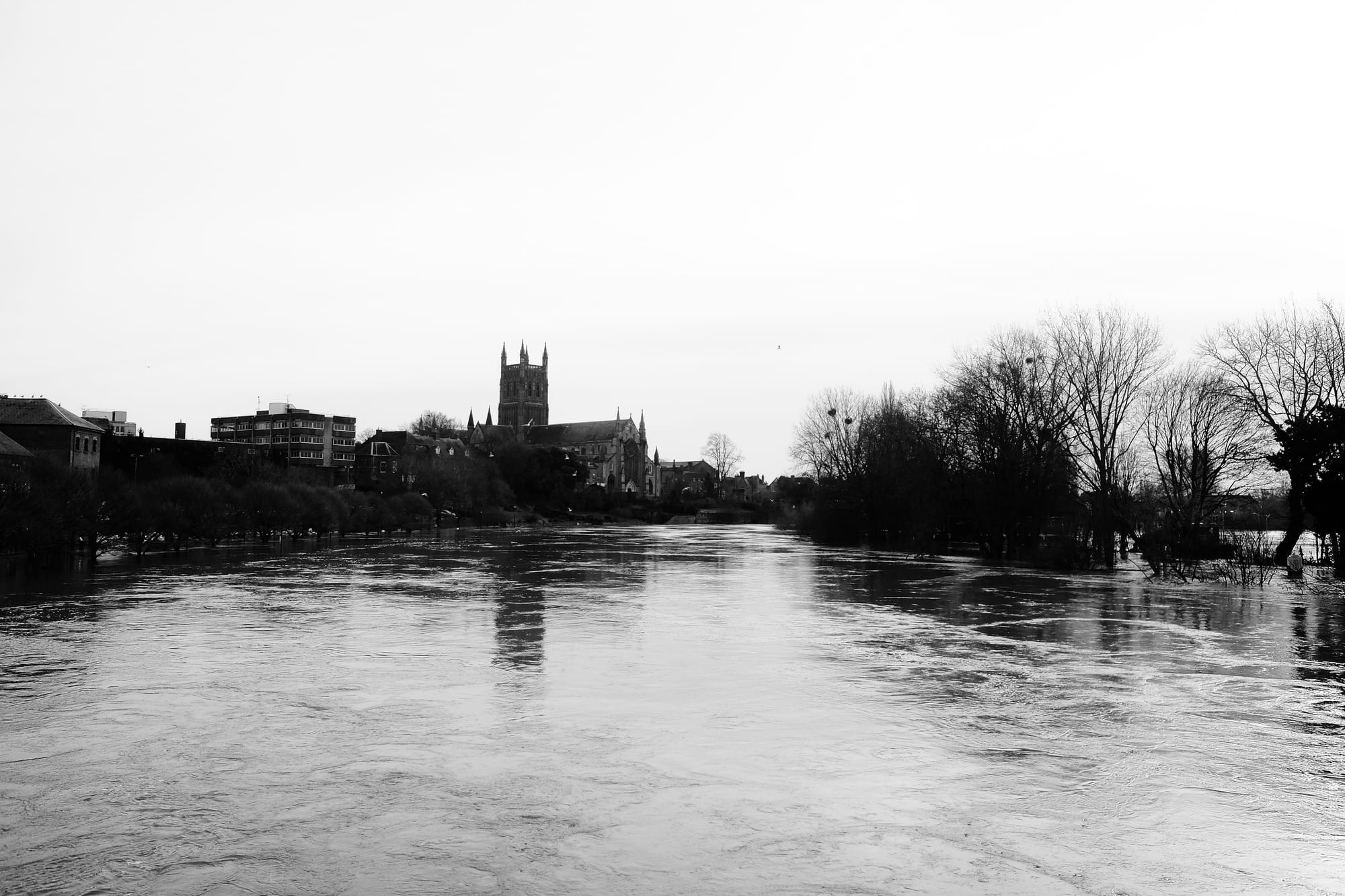 A black and white image of the flooded River Severn, Worcester Cathedral in the background