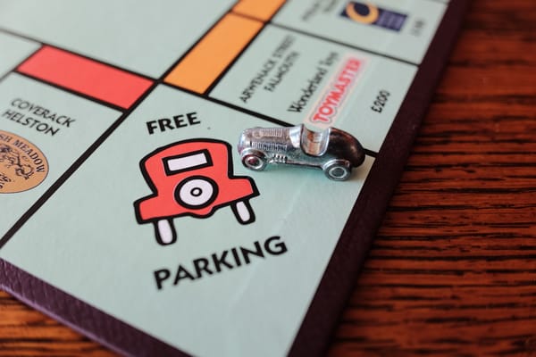 The free parking square on a Monopoly board with the racing car playing piece sitting on it.